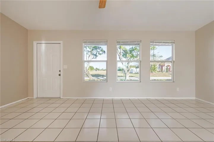Spare room with ceiling fan and light tile patterned floors