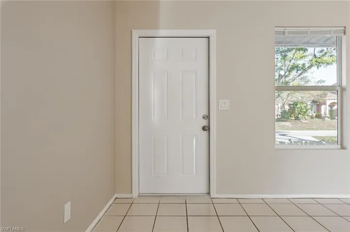 Doorway featuring light tile patterned flooring