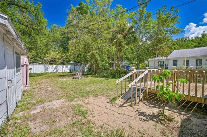 View of yard with fence and a wooden deck