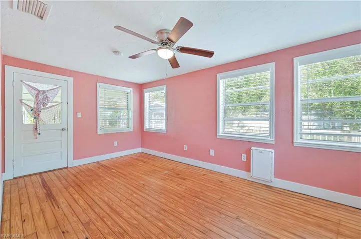 Entryway with visible vents, baseboards, light wood finished floors, and a ceiling fan