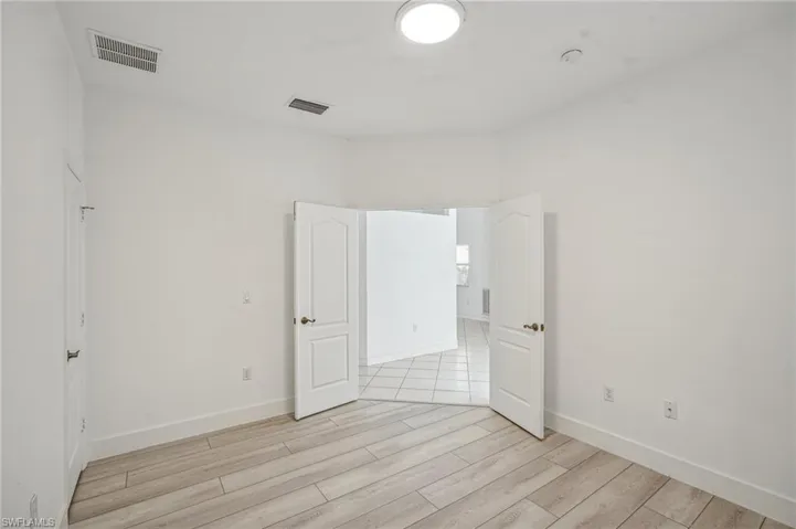 Unfurnished bedroom with light wood-style floors and baseboards