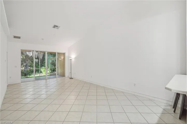 Spare room featuring baseboards and light tile patterned floors