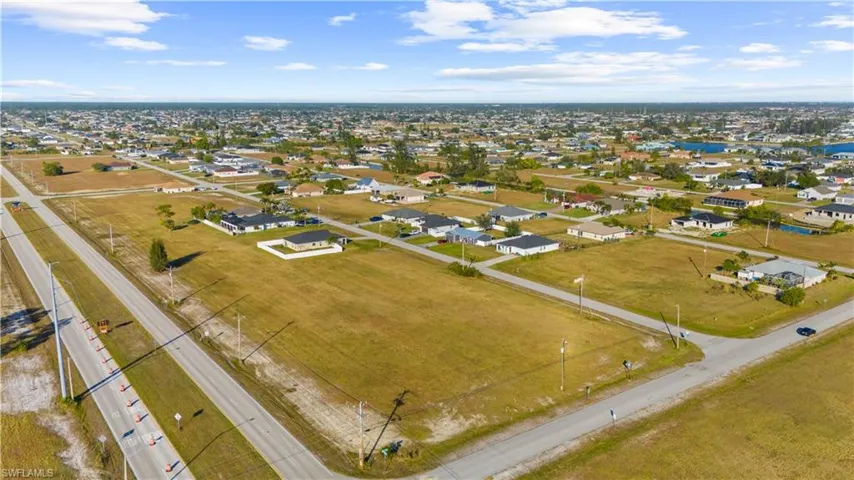 Expansive aerial view showcasing multiple vacant land parcels alongside existing residential properties