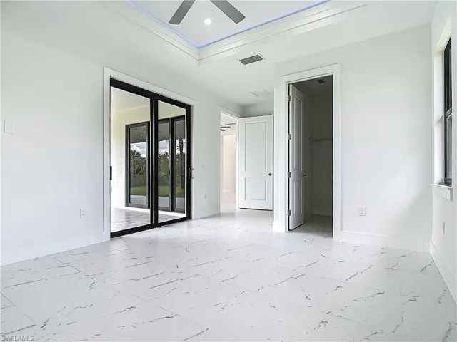 Spare room with light marble finish flooring, ceiling fan, and recessed lighting