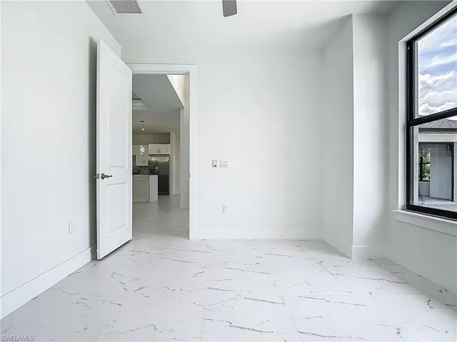 Empty room with light marble finish floors and baseboards