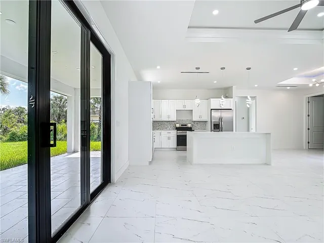 Unfurnished living room featuring light marble finish flooring, recessed lighting, and ceiling fan