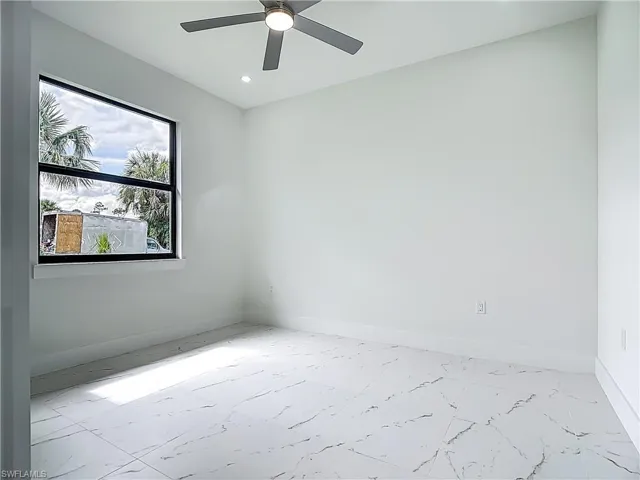Unfurnished room with recessed lighting, ceiling fan, and marble finish flooring