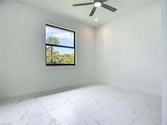Unfurnished room with marble finish flooring, ceiling fan, and recessed lighting