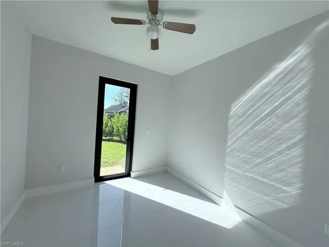 Spare room with light tile patterned floors and ceiling fan