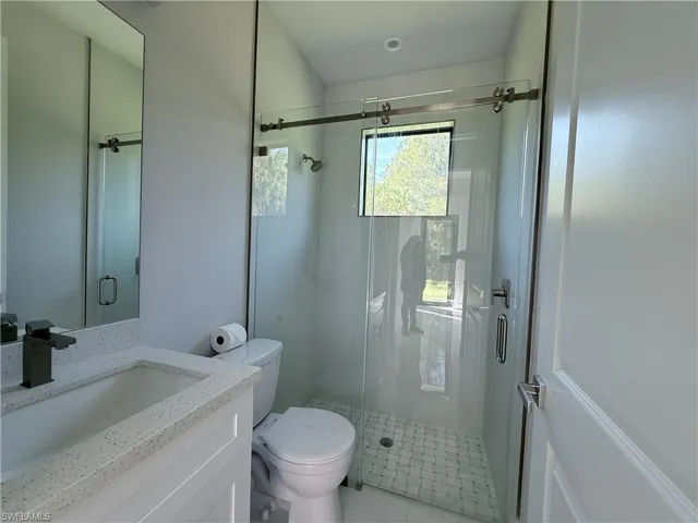 Bathroom featuring vanity and a shower stall