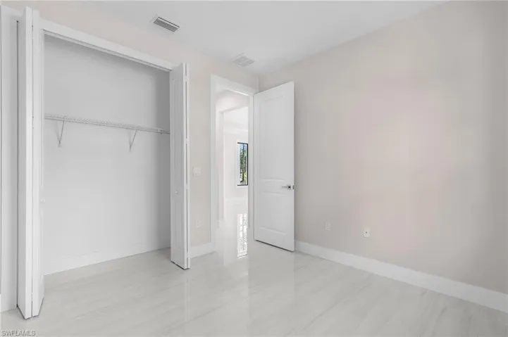 Unfurnished bedroom featuring baseboards and a closet
