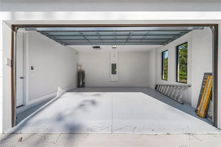 Garage with electric water heater and electric panel