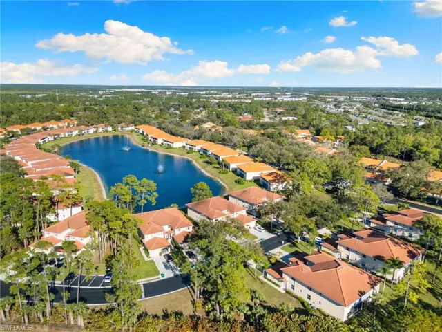 Aerial view of residential area featuring a nearby body of water