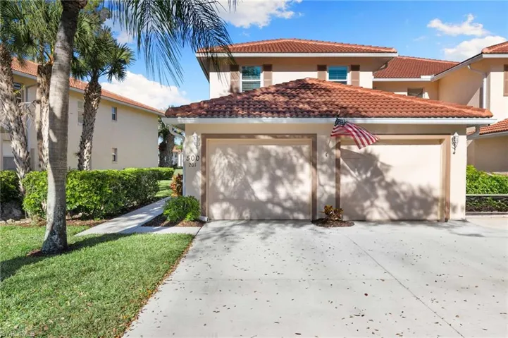Mediterranean / spanish-style house with stucco siding, driveway, a tiled roof, and a garage