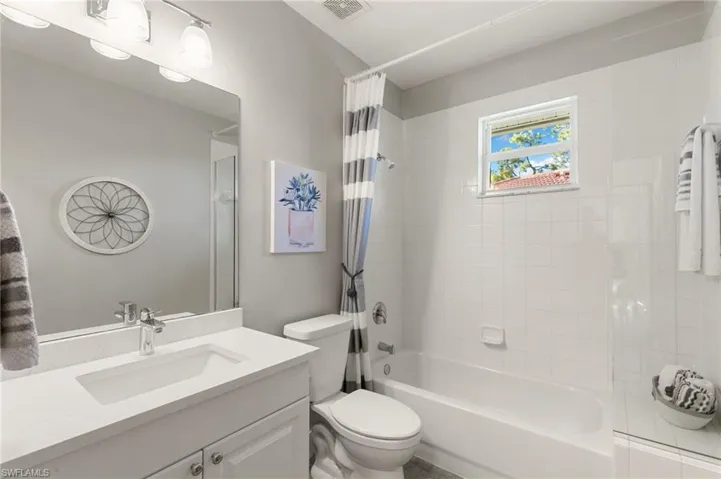 Bathroom featuring shower / bath combo and vanity