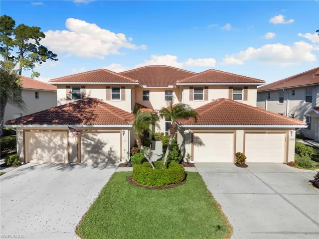 Mediterranean / spanish house with stucco siding, a tiled roof, and driveway