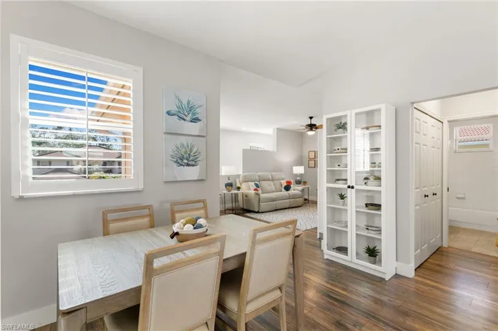 Dining room featuring plenty of natural light, dark wood-style flooring, and ceiling fan