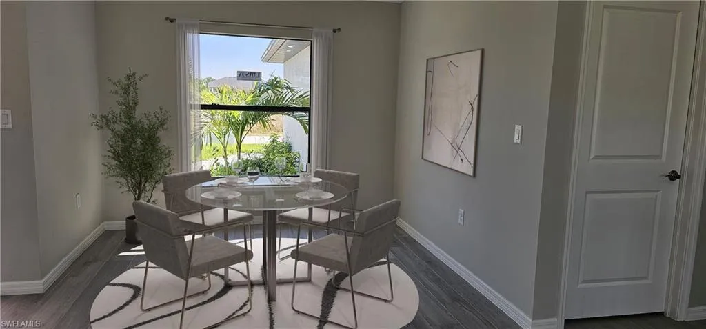 Dining space featuring wood finished floors and baseboards