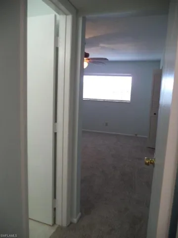 Hallway with a baseboard heating unit