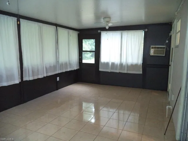 Spare room featuring ceiling fan and light tile patterned floors