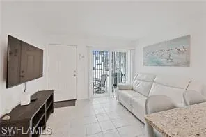 Living room with light tile patterned flooring