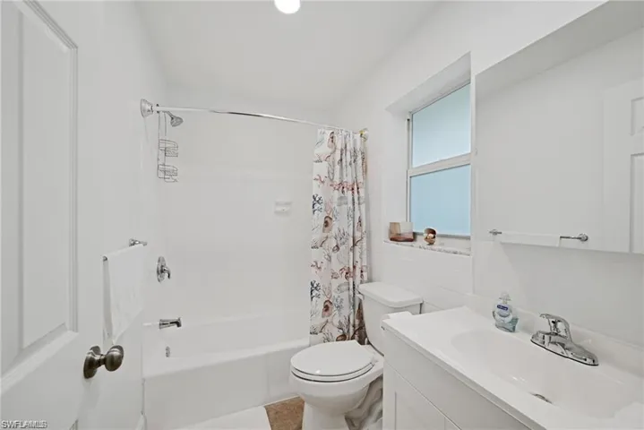 Full bath with shower / bath combination with curtain and vanity