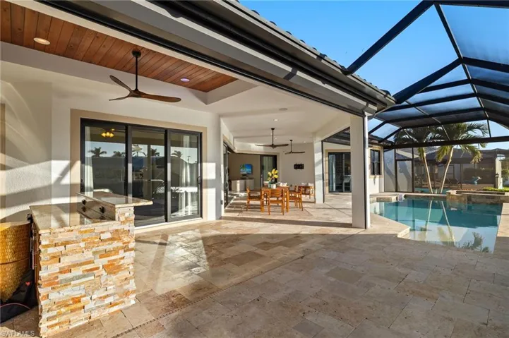 View of patio/ lanai, ceiling fans, built in kitchen with Bull Grill.