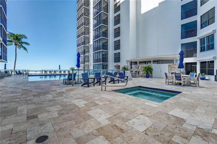 Community pool with a hot tub and a patio