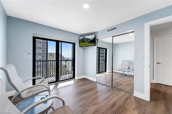 Guest bedroom featuring a nice size screened private balcony, wood finished floors and recessed lighting