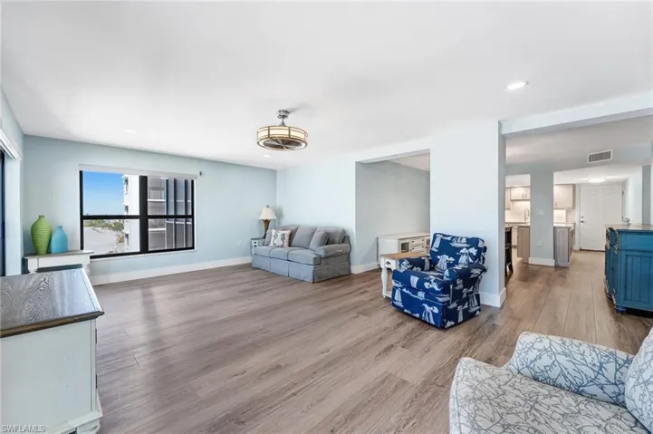 Huge Living area with recessed lighting and light wood-type flooring