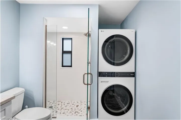 Washroom with stacked washer / drying machine