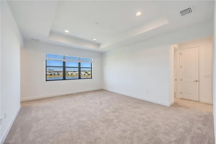 Grand primary bedroom with double door entry