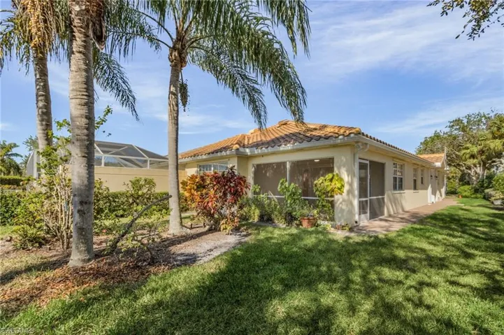 Rear view of property with a yard