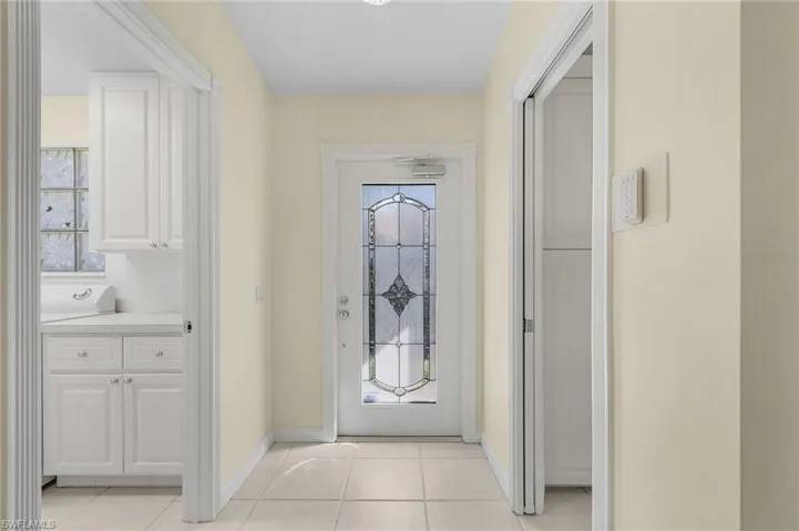 Doorway to outside featuring light tile patterned floors