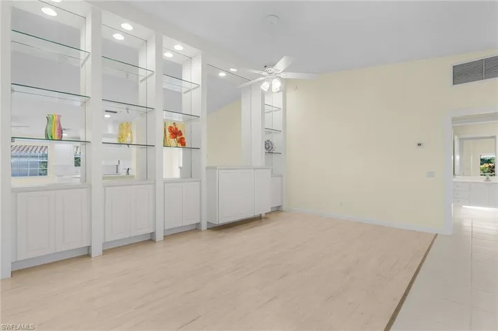 Unfurnished room featuring ceiling fan, plenty of natural light, and light hardwood / wood-style flooring