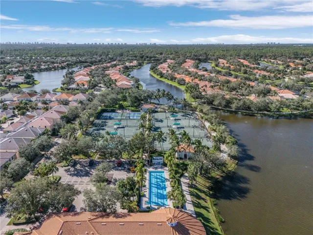 Birds eye view of property with a water view