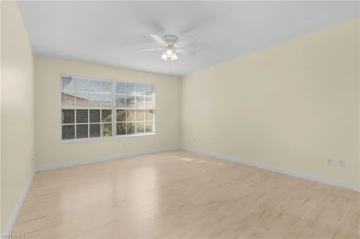 Spare room featuring ceiling fan and light wood-type flooring