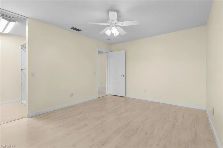 Unfurnished room featuring light wood-type flooring and ceiling fan
