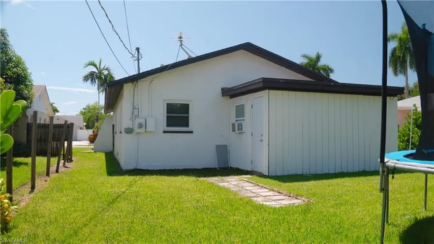 Back of house featuring a trampoline