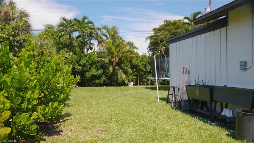 View of green lawn with a trampoline