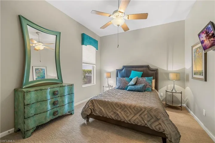 Carpeted bedroom with ceiling fan