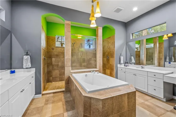 Bathroom with dual vanity, plus walk in shower, and tile patterned floors