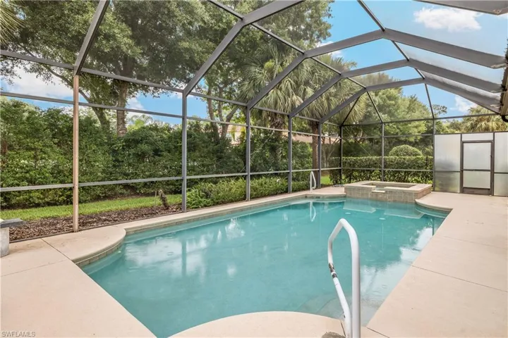 View of swimming pool featuring an in ground hot tub and a lanai