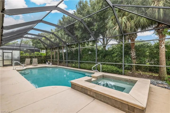 View of pool with a patio, an in ground hot tub, and a lanai