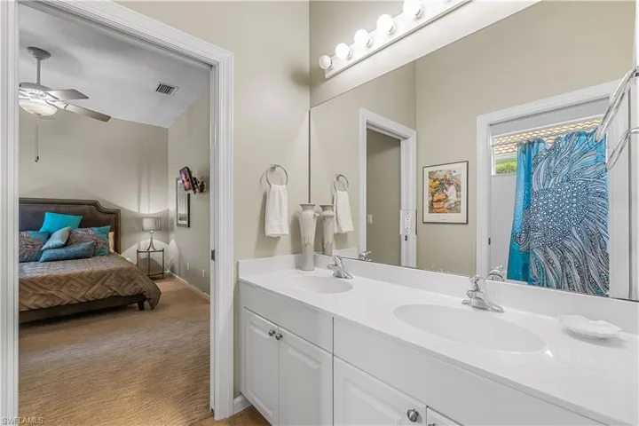 Bathroom with dual vanity and ceiling fan
