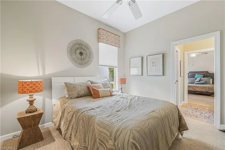 Carpeted bedroom with ceiling fan
