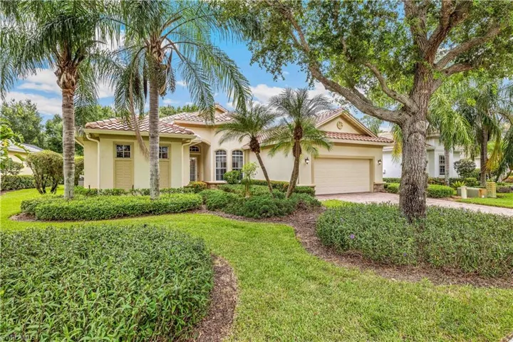 Mediterranean style home featuring a 2 car garage and a front yard