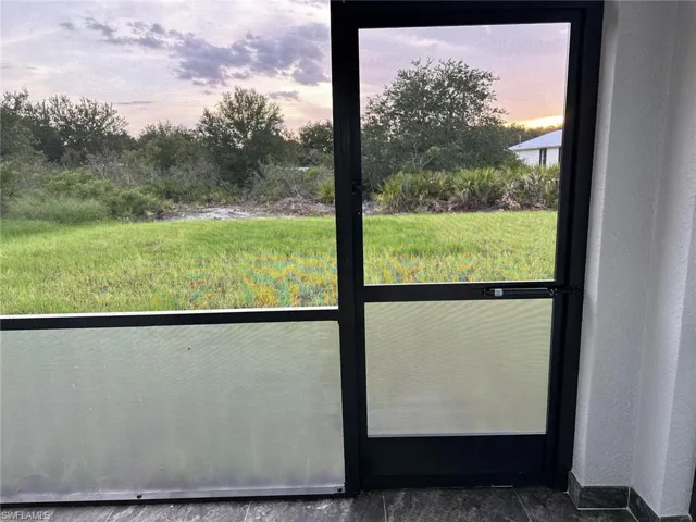 Doorway to outside with baseboards