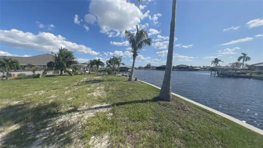 Left side from middle of seawall on OVERSIZE SOUTHERN rear Exposure Gulf Access lot with NEW (12/2021) 121' SEAWALL - BIG WATER VIEWS