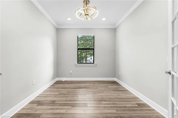 Unfurnished room with crown molding, light wood-type flooring, and recessed lighting